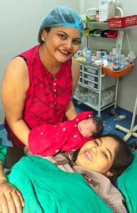 Dr. Pranali Meshram providing compassionate maternity care to a mother and newborn in a hospital